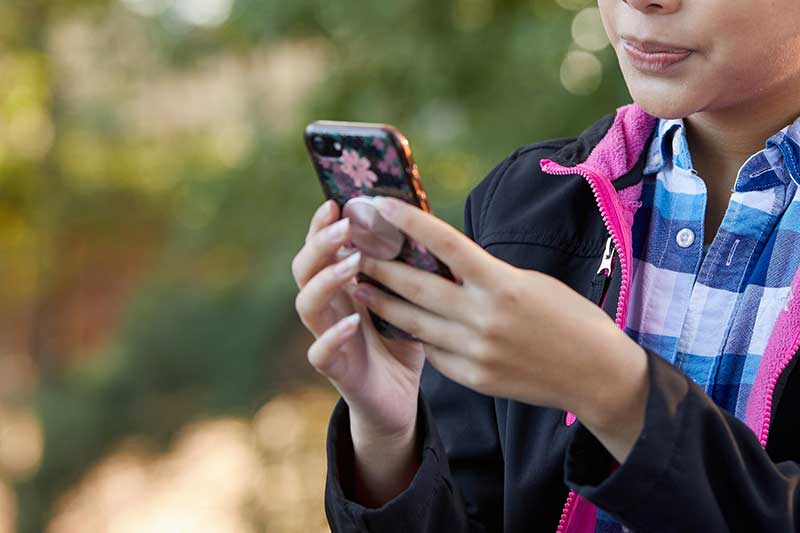 close up of kid looking at social media