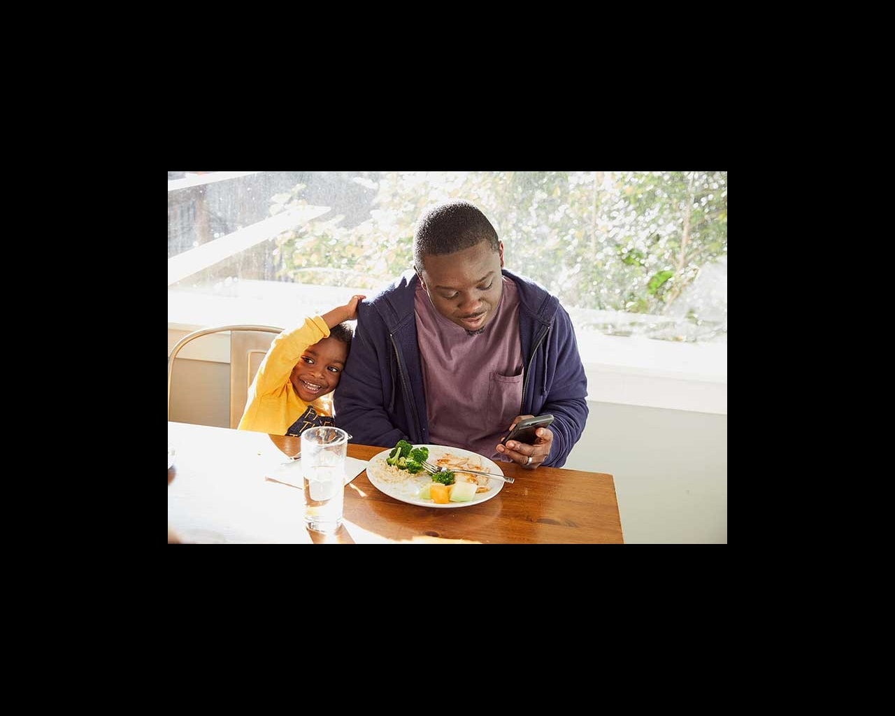 dad on phone at dinner table