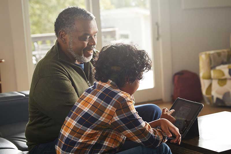 grandfather and young boy on tablet