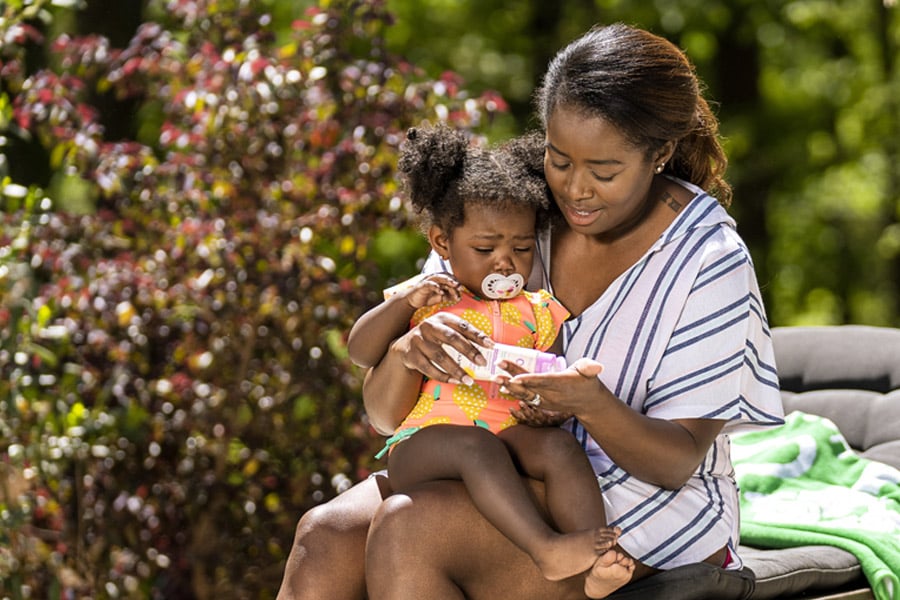 mom putting sunscreen on infant