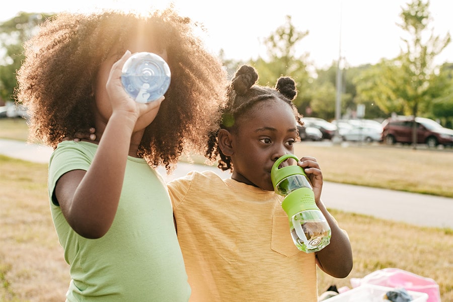 two girls drinking water