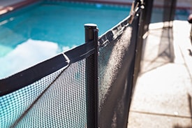 An image showing a pool fence used as a layer of drowning prevention.