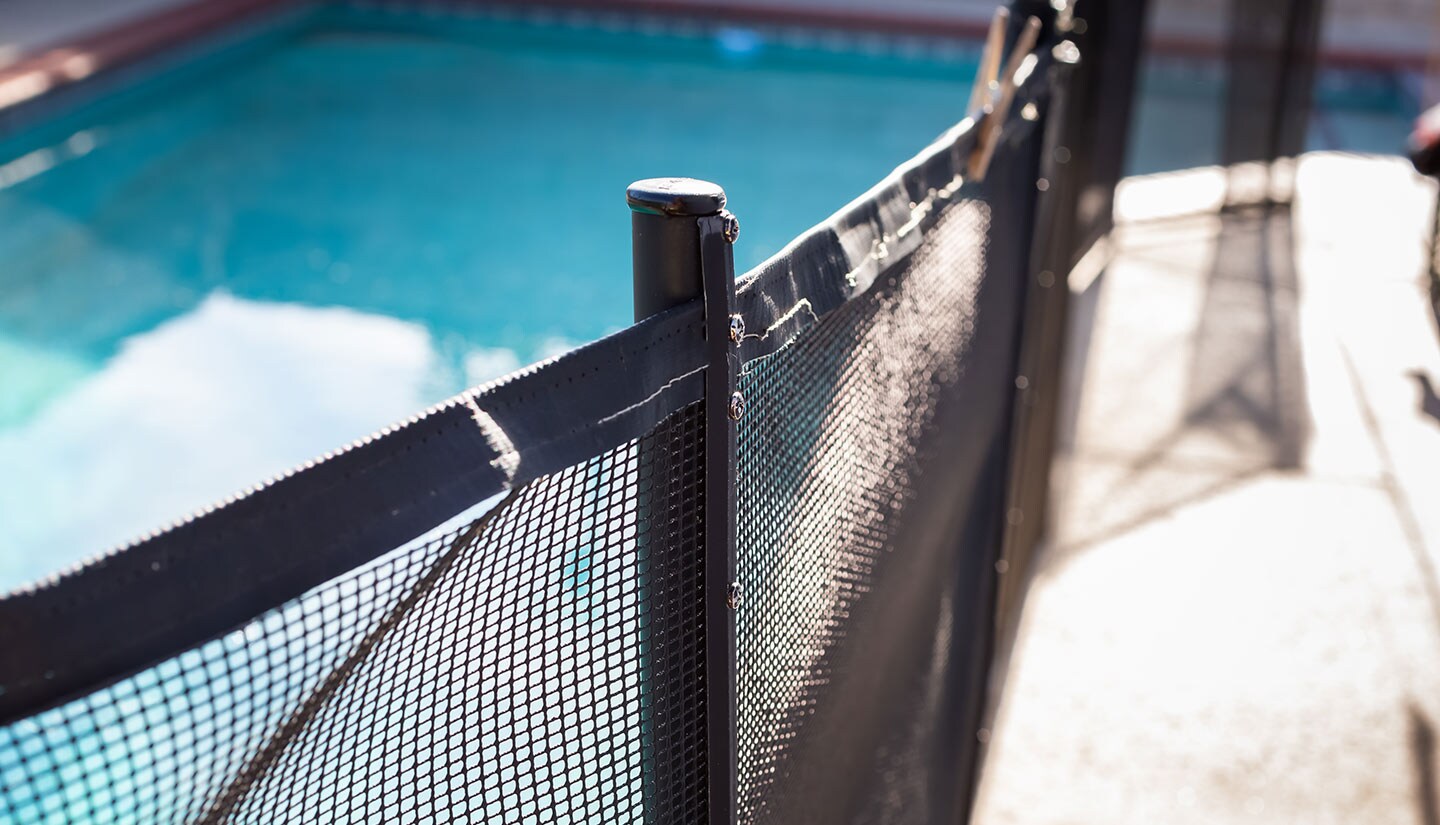 An image showing a pool fence used as a layer of drowning prevention.