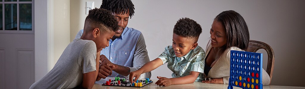 family playing board game together