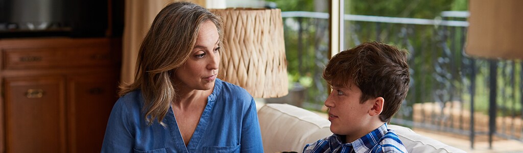 mom talking to son on couch