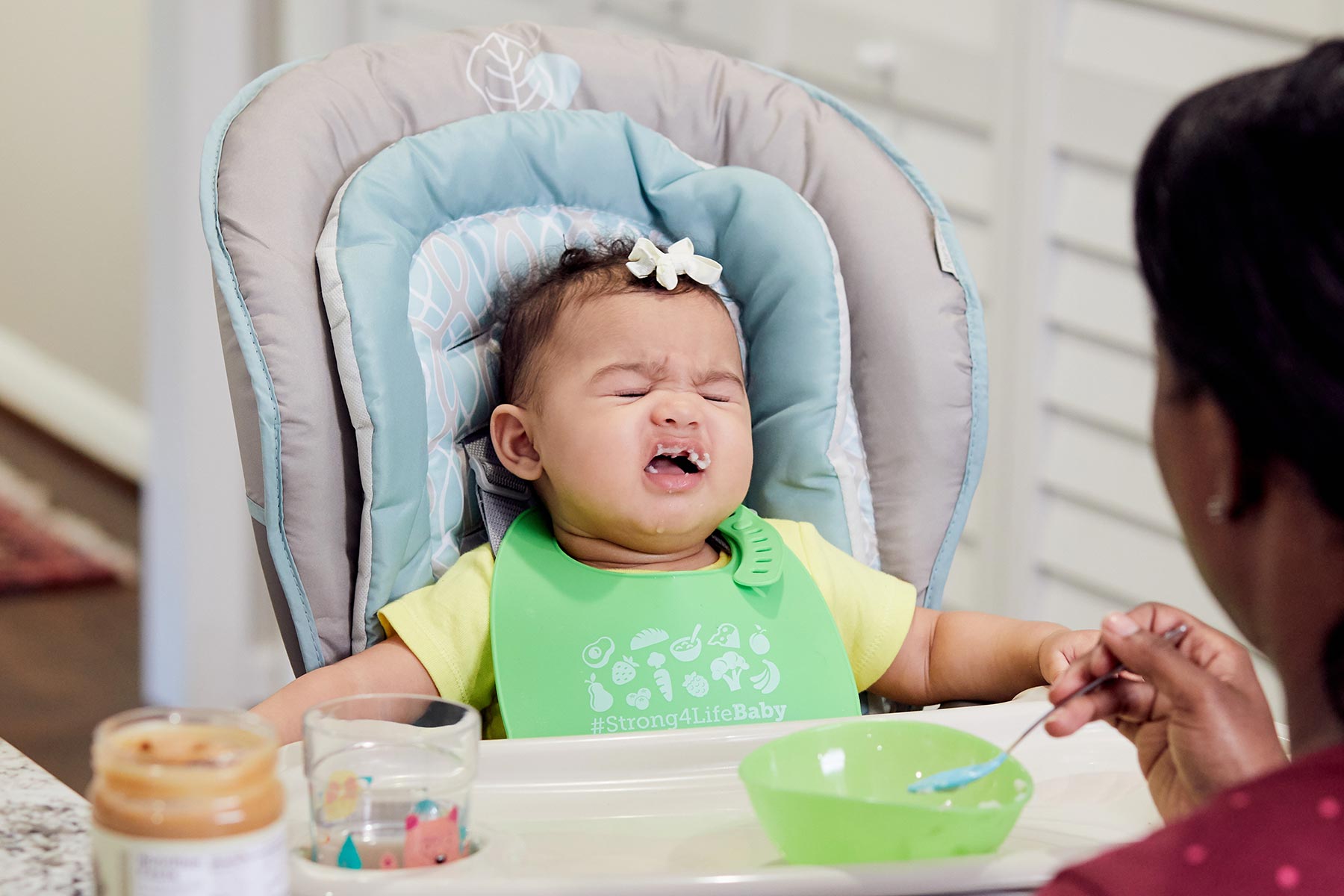 5 month old being spoon fed peanut butter