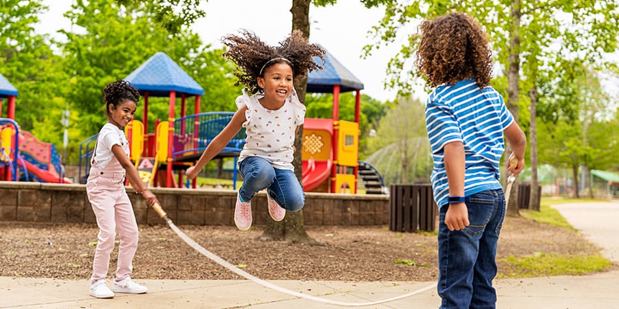 Kids playing jump rope at a playground