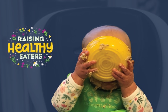 Infant eating a bowl of oatmeal alongside graphic which says "Raising Healthy Eaters"